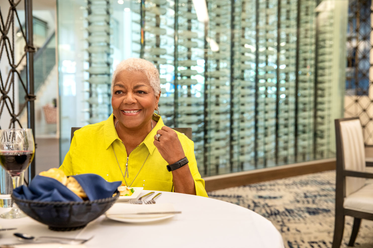 Female arbor terrace resident sitting at dinner table