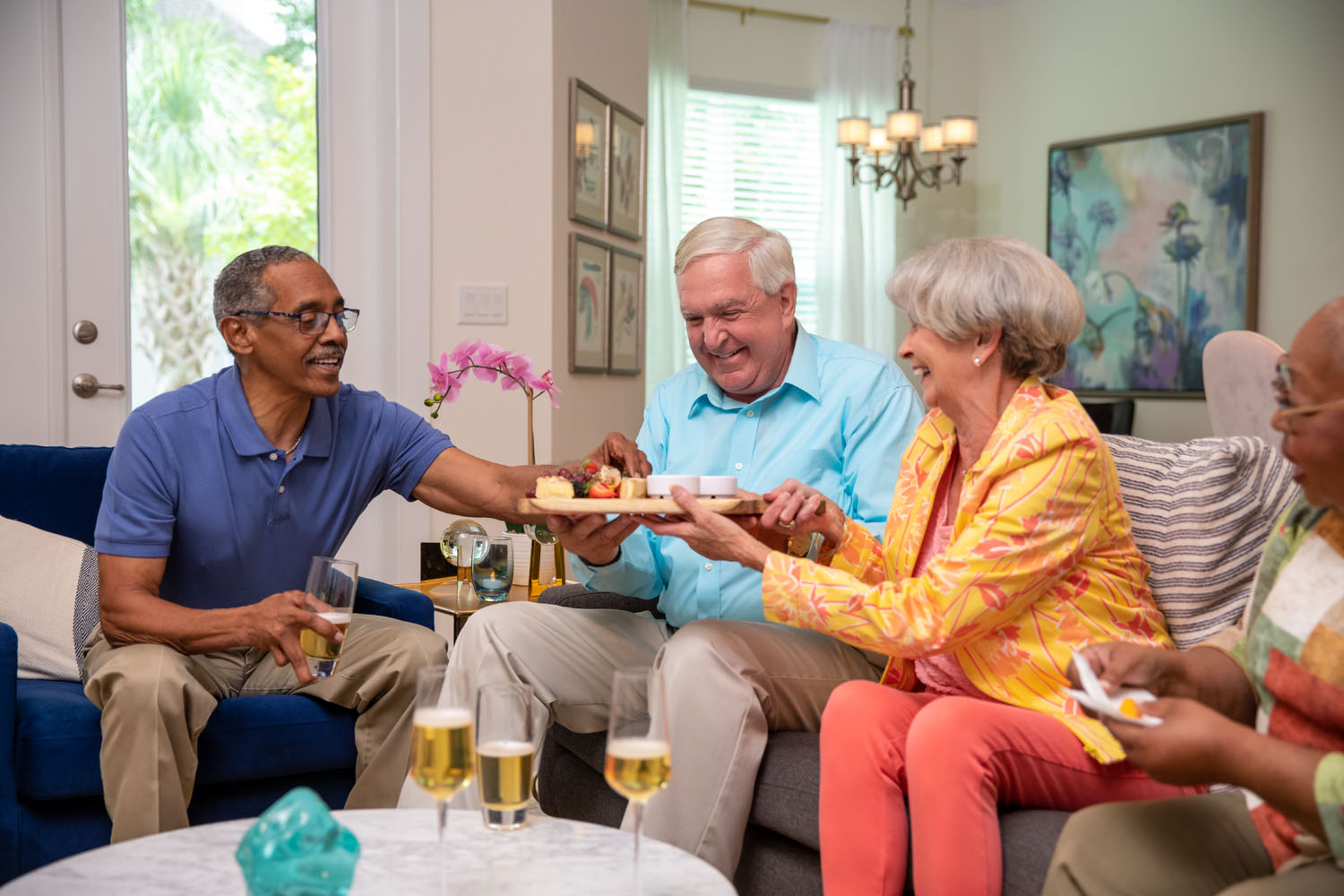 arbor terrace residents on couch having hors d'oeuvres
