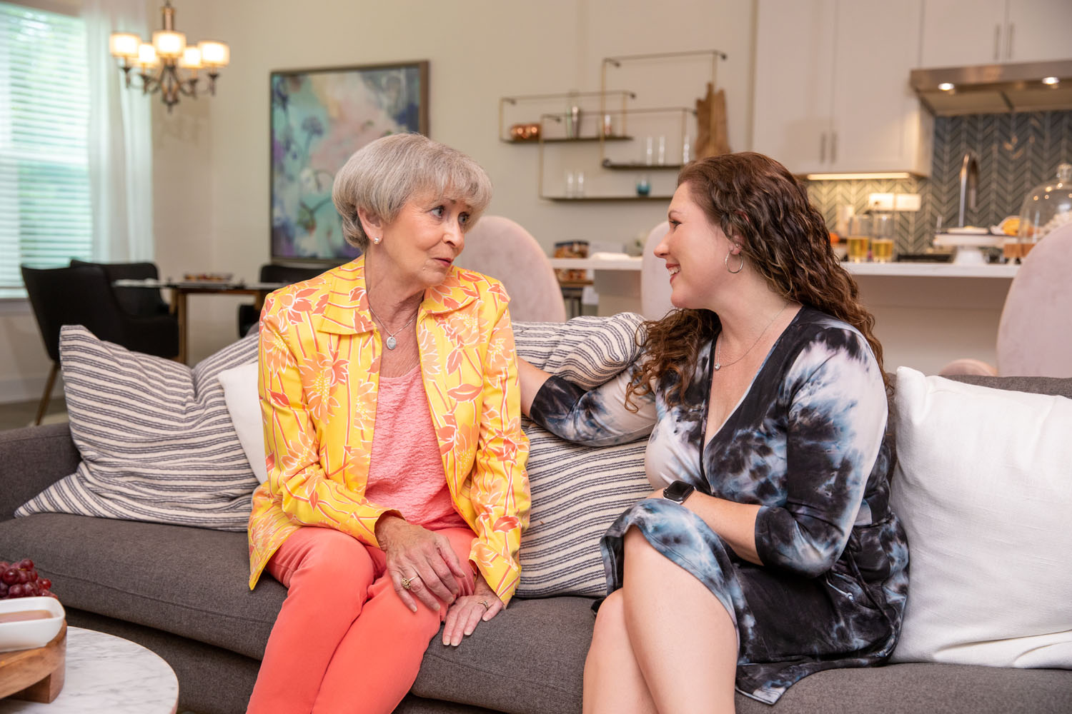 arbor terrace residents and family member talking on couch