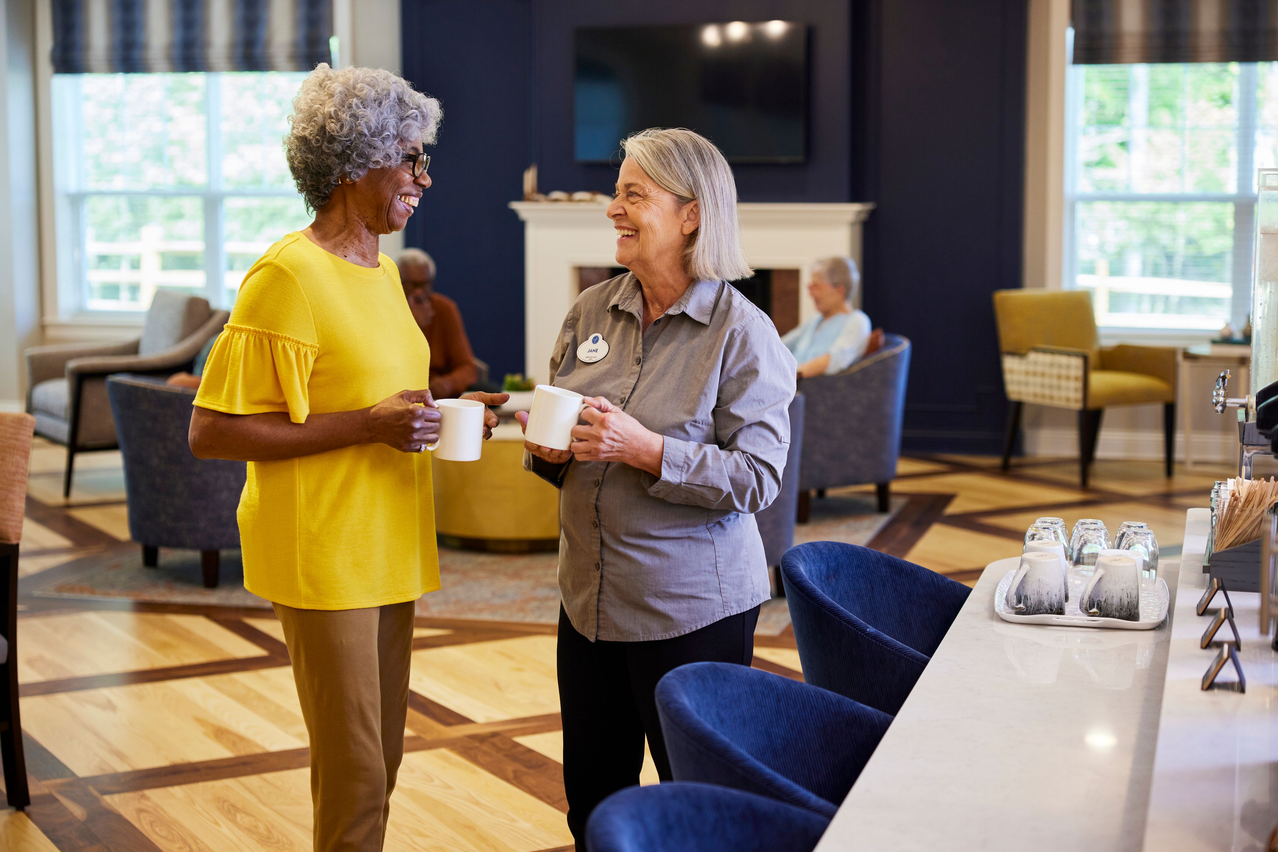 arbor terrace residents talking and drinking coffee in bistro