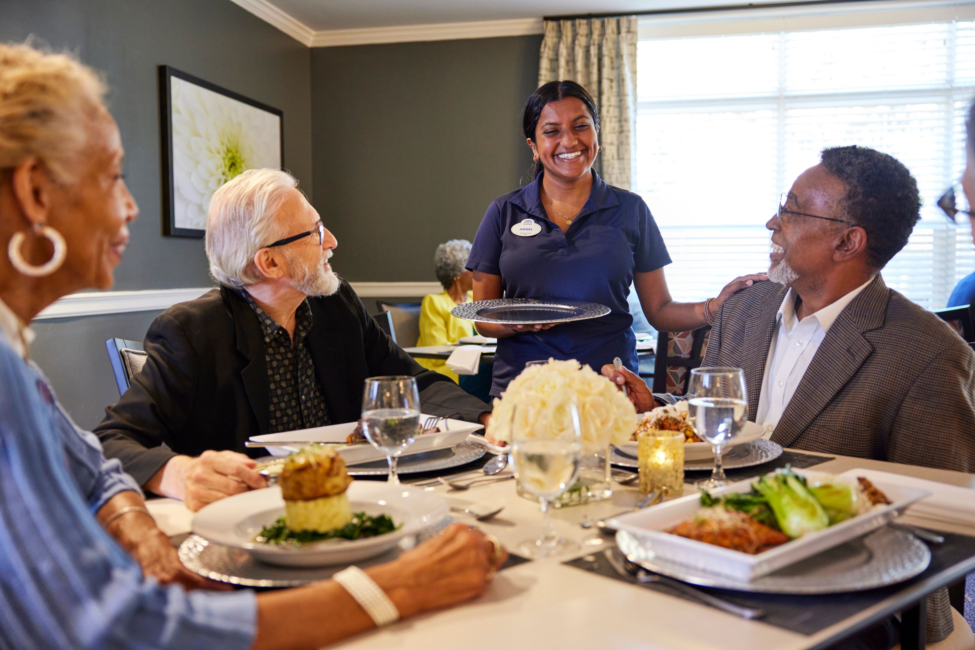 arbor terrace residents being served meals in dining room