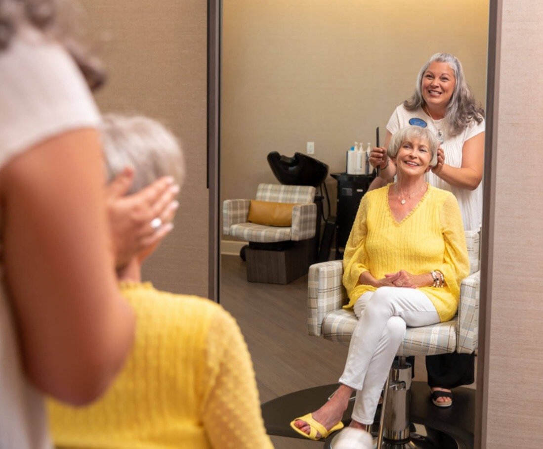 arbor terrace staff styling resident's hair in salon