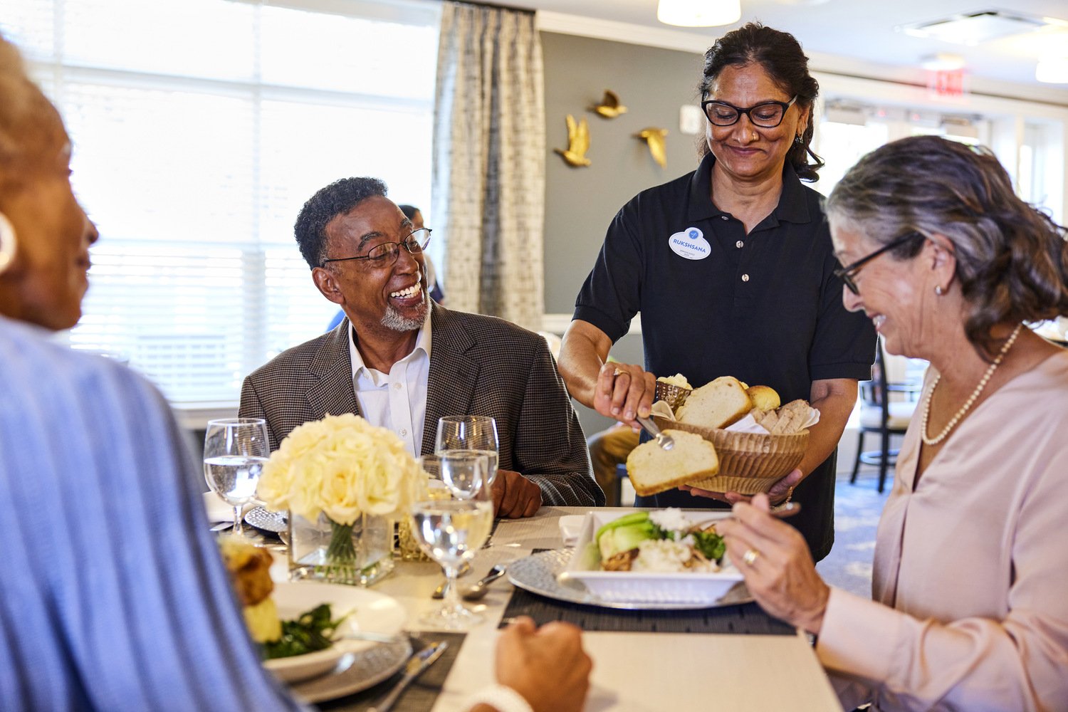 TheArborCompany_SeniorsBeingServedDinner