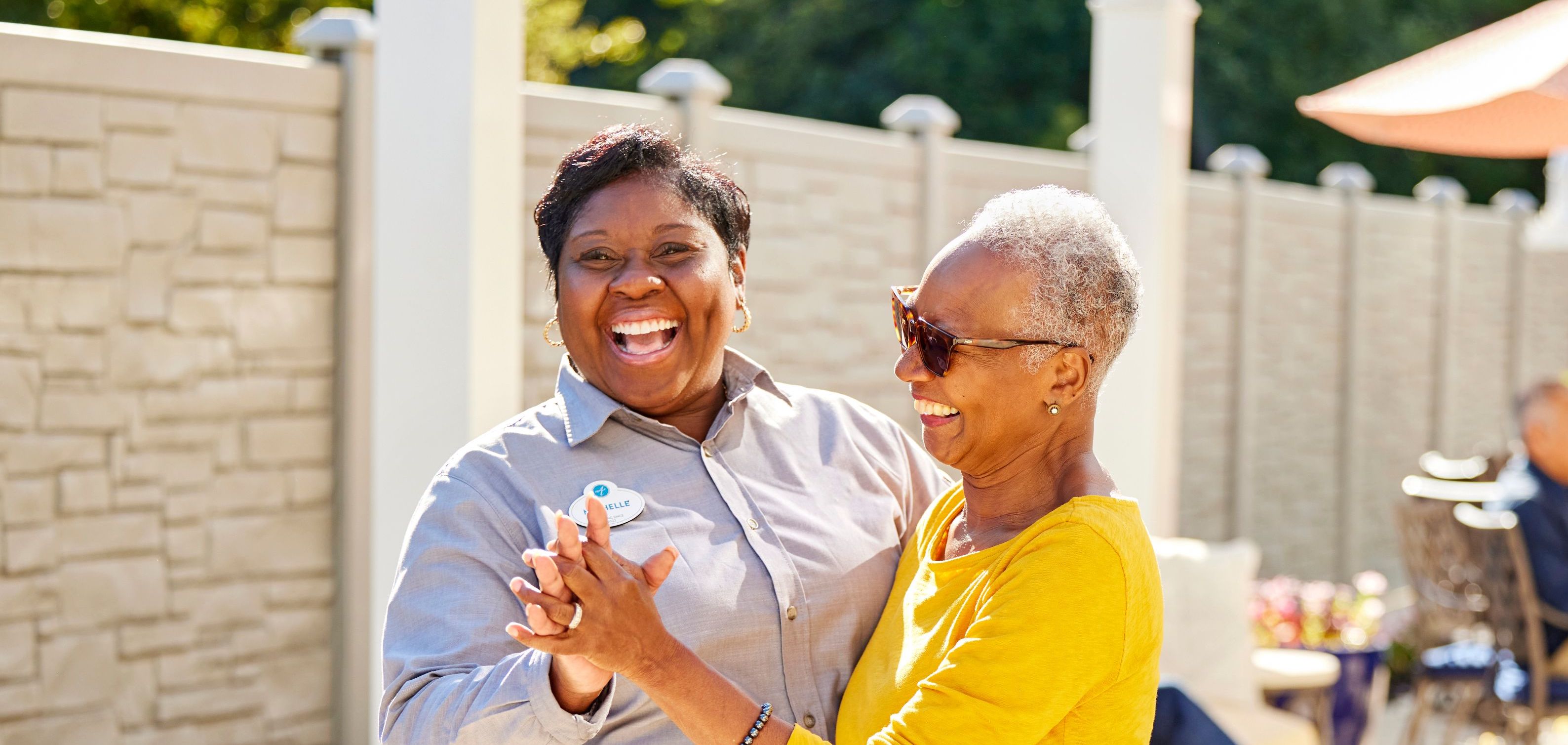 arbor terrace resident and staff dancing together
