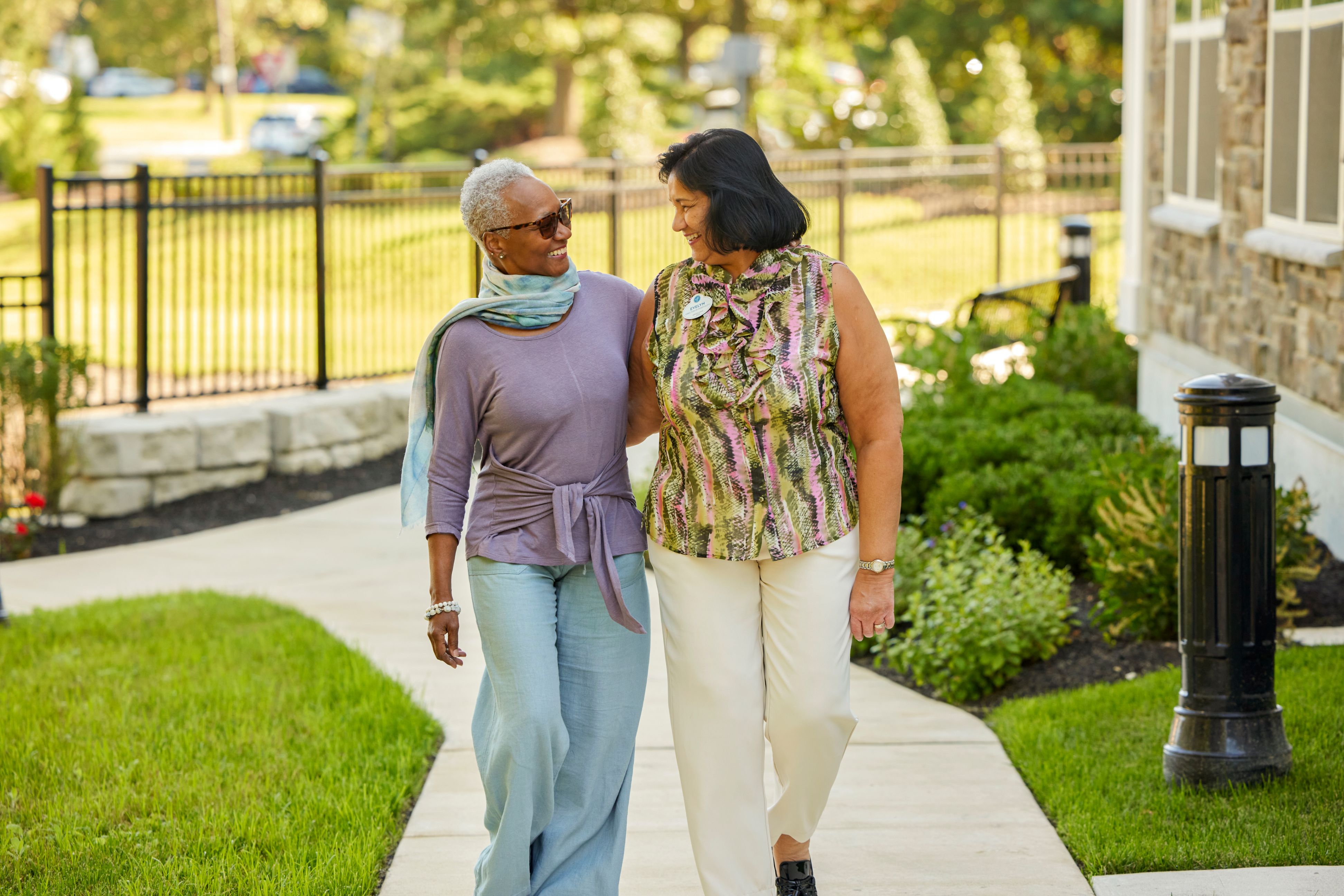 arbor terrace resident and staff walking outdoors