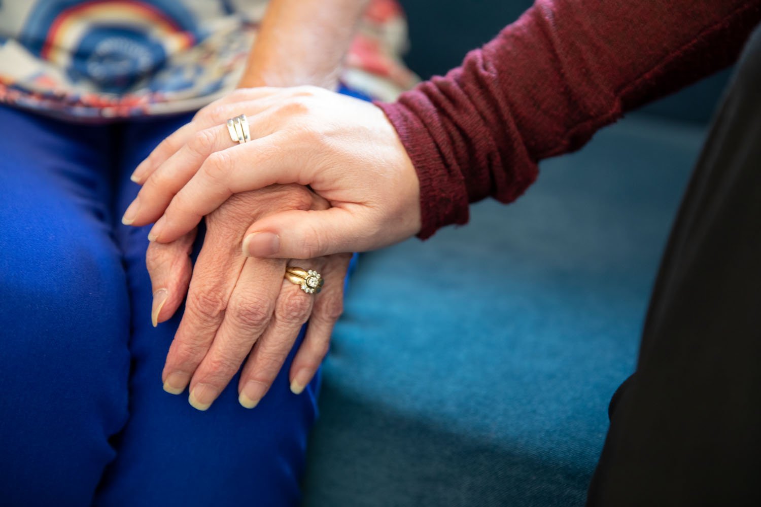 arbor terrace resident and staff holding hands